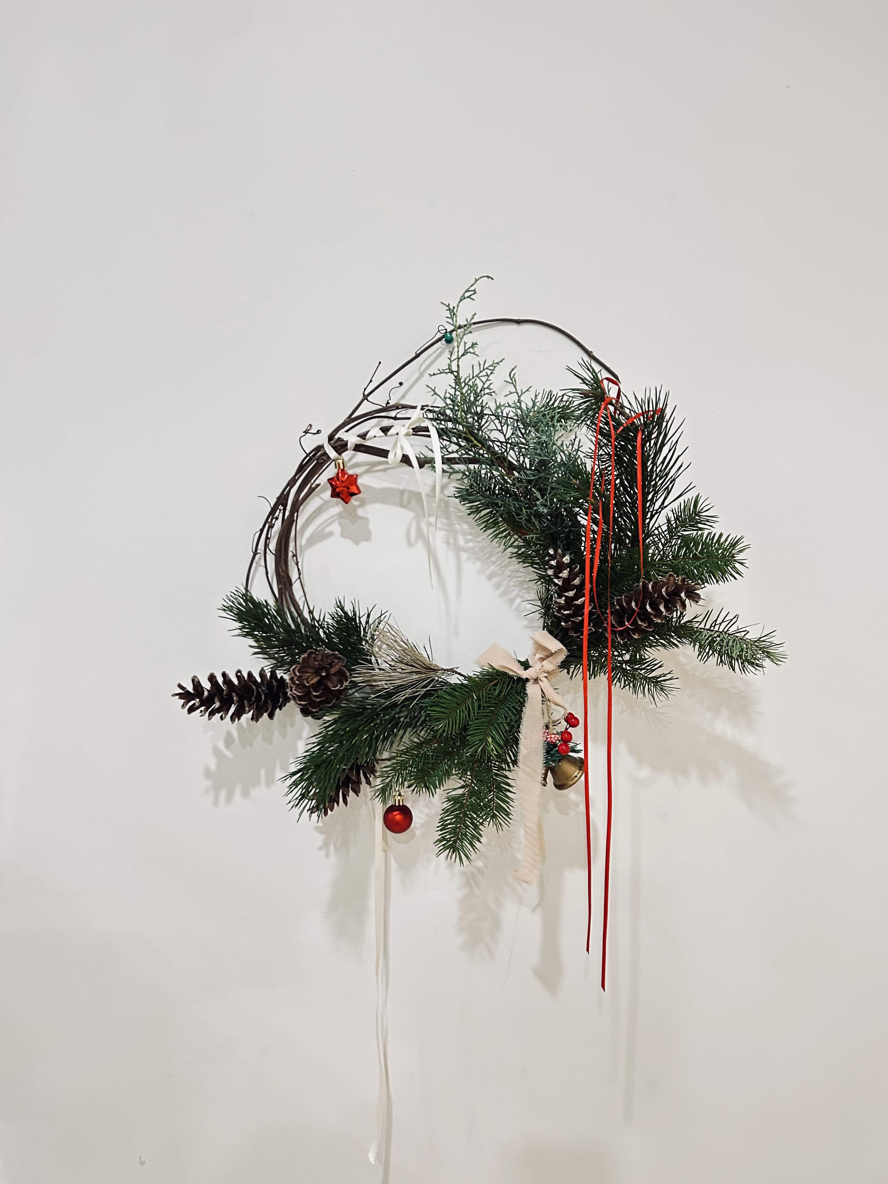 Jingle all the wreath - Wreath is available in one size. Decorated with Christmas greenery, ribbons, Christmas ornaments, and pine cones! Perfect for this season and for your door!   