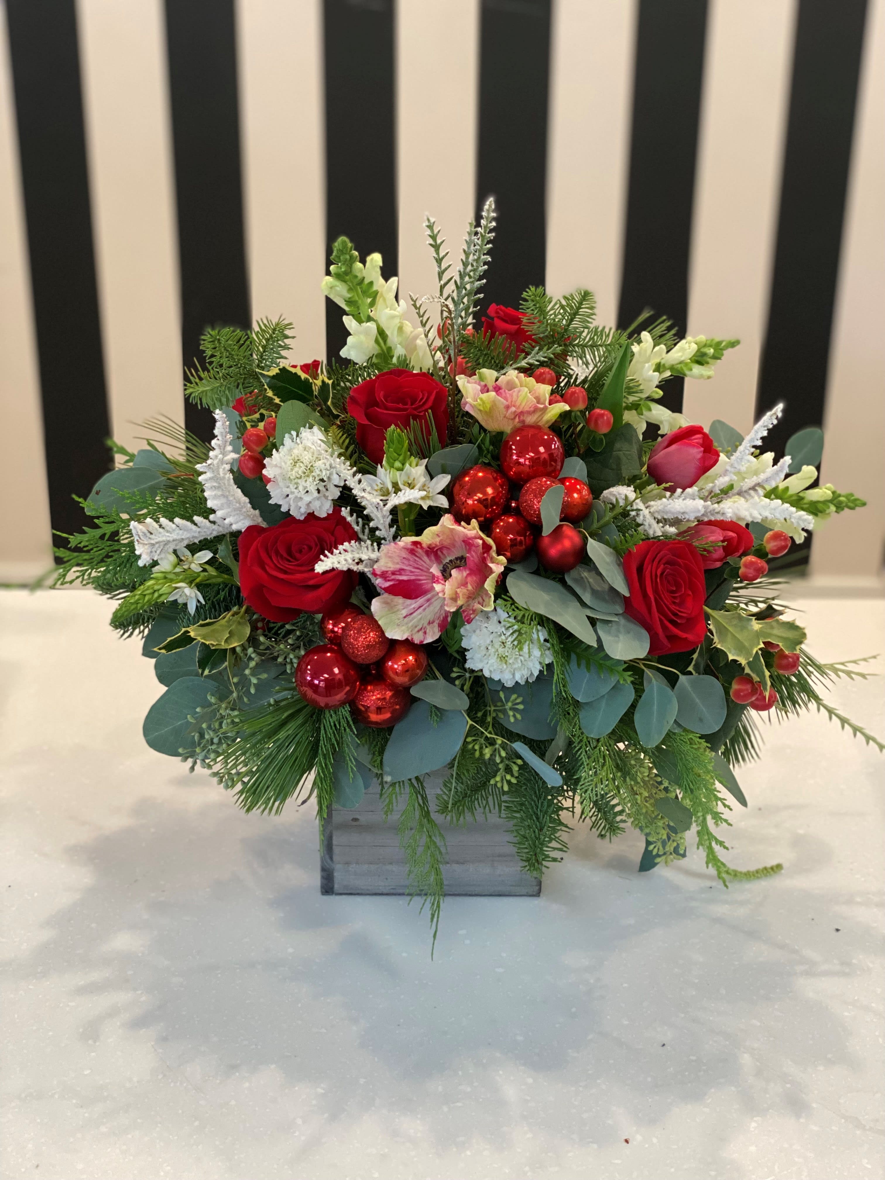 Holly Jolly Christmas - This arrangement includes premium blooms and festive holiday ornaments. 