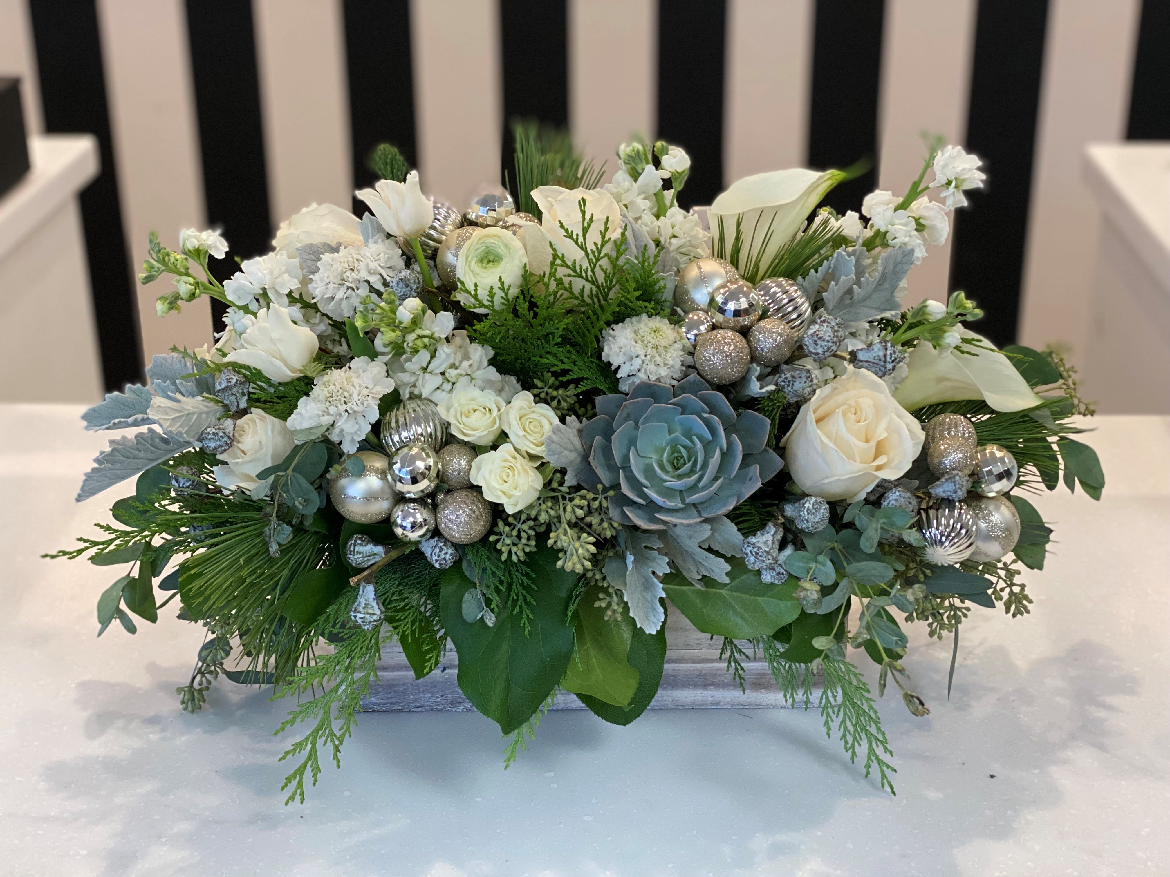 White Christmas - This arrangement includes a variety of beautiful premium blooms with a festive holiday flare. 