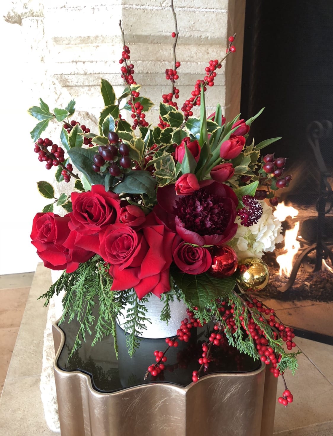 HOLIDAY HAPPINESS  - This design has Red France roses, tulips, peonies,berries,hydrangea,and amazing smelling Christmas greens! All nestled in a beautiful 7x7 round white container....