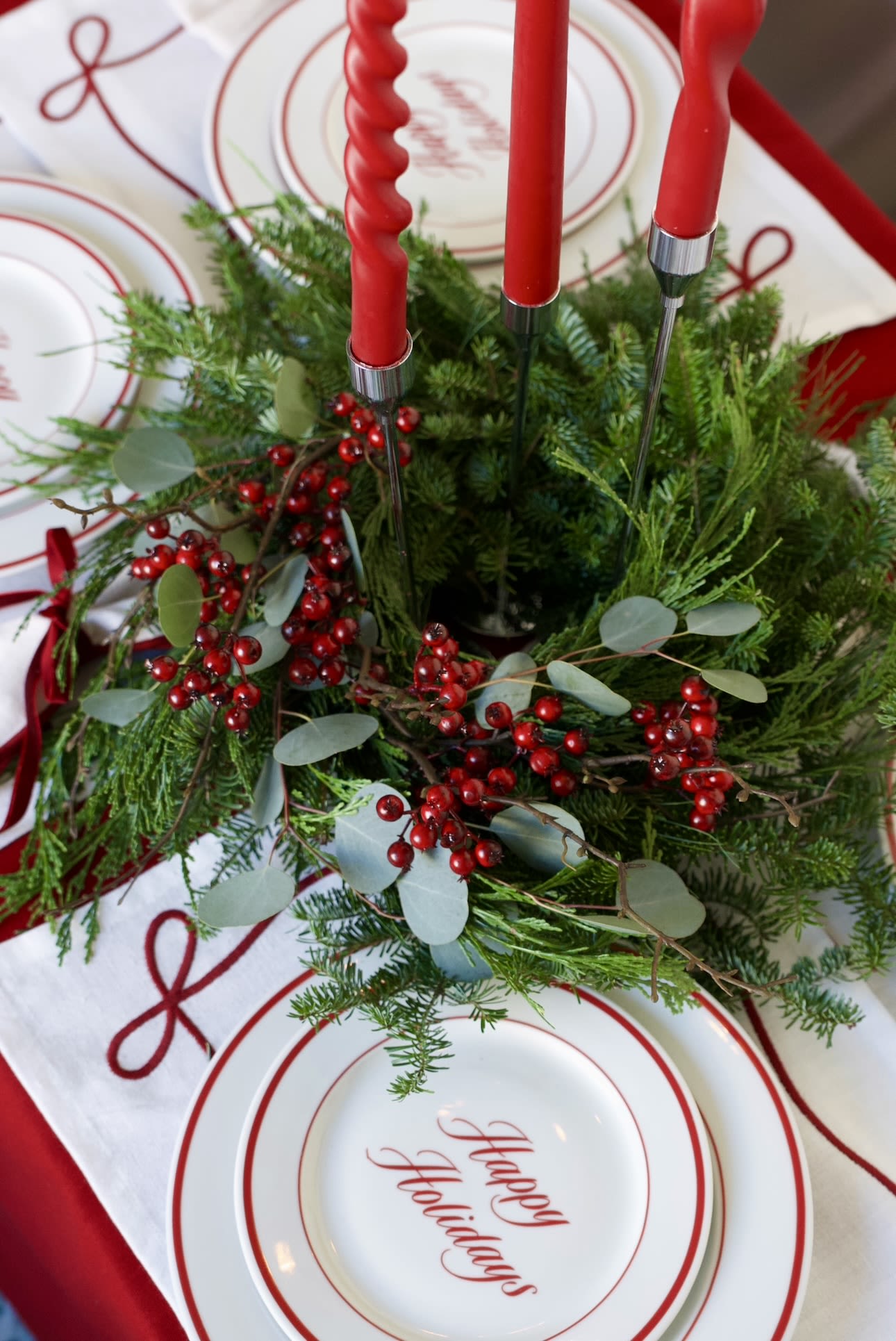 Candlelight Forest Wreath  - A lush fresh evergreen candle wreath, handcrafted from fir, pine, cedar, eucalyptus, and accented with faux ilex berries. Perfect as a holiday table centerpiece or mantle décor.  The wreath shown in the photo is the Medium (12-inch) size. Candles not included — wreath only. Next-day delivery available.