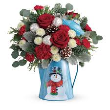 Frosty Enchantment Bouquet - Send a warm holiday greeting with this frosty fun gift of festive red and white blooms, hand-arranged in a vintage-inspired metal kettle with smiling snowman! This festive arrangement includes red roses, red carnations, red miniature carnations, white button spray chrysanthemums, silver dollar eucalyptus, dusty miller, flat cedar, and noble fir. Delivered in a Snowy Daydreams kettle.