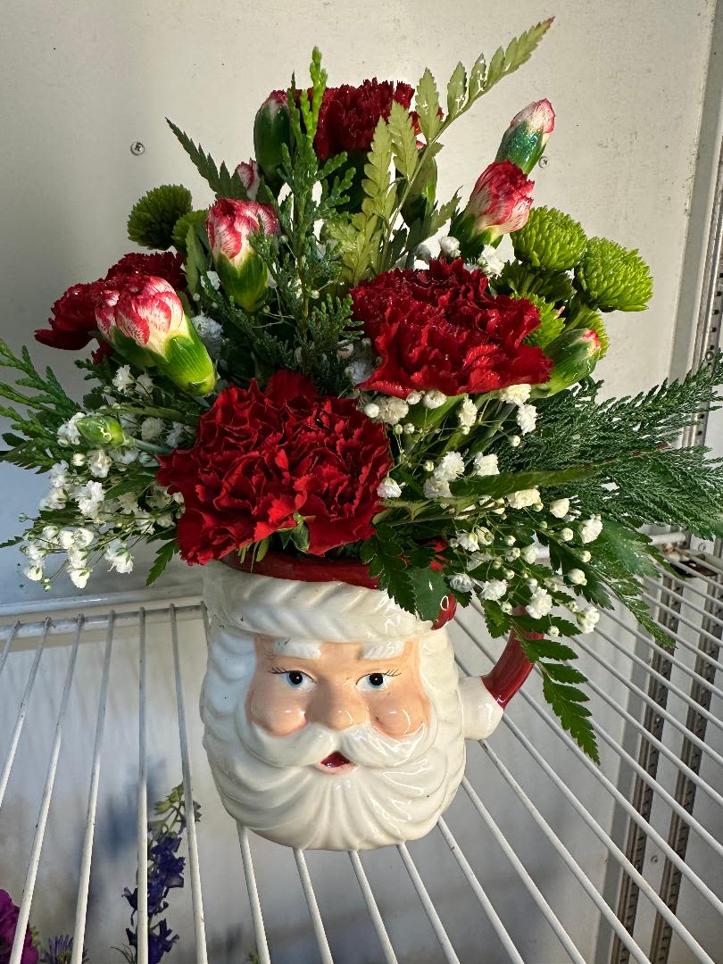 Santa Claus is Coming to Town - Jolly Old Saint Nicholas brings your flowers with this amazing array of Holiday greens, red and white