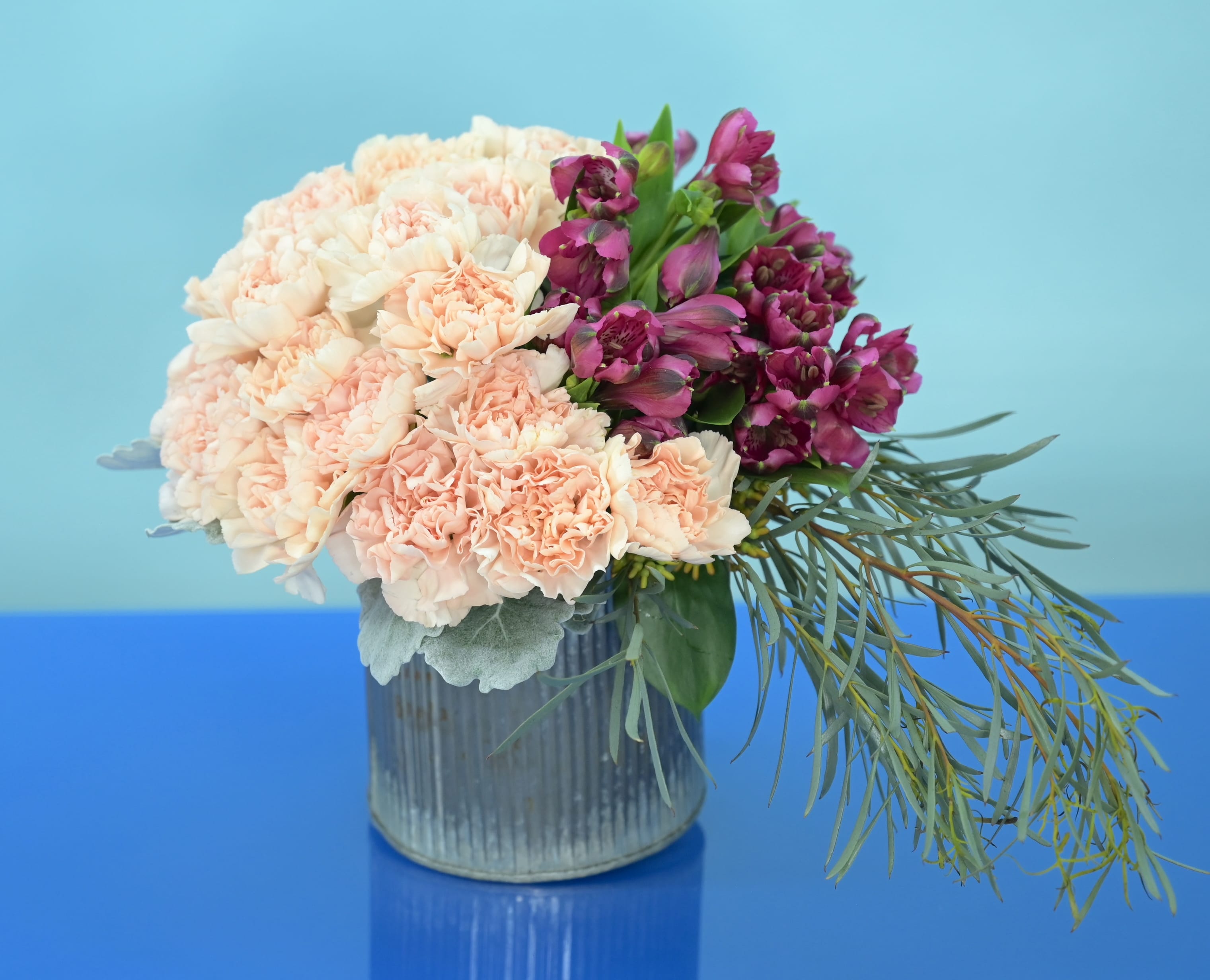 Rustic Flowers of Cary - Rustic Flowers of Cary Warm, textural, and beautifully inviting, Rustic Flowers of Cary blends soft garden tones with rich, moody accents for a design that feels both modern and naturally grounded. The arrangement’s rounded silhouette and layered textures create a sense of effortless charm, while the ribbed vessel adds a contemporary rustic touch. Perfect for gifting, home décor, or bringing a polished yet relaxed elegance to any space, this piece embodies the welcoming spirit of Cary with elevated floral artistry. Please Note: Our arrangements are handcrafted, and no two pieces are ever identical. Variations in flower types, color tones, and exact placement will occur based on daily availability. We do not create factory-duplicate designs — instead, we recreate the style, palette, and overall feel of the arrangement while ensuring every piece is fresh, beautiful, and premium.  