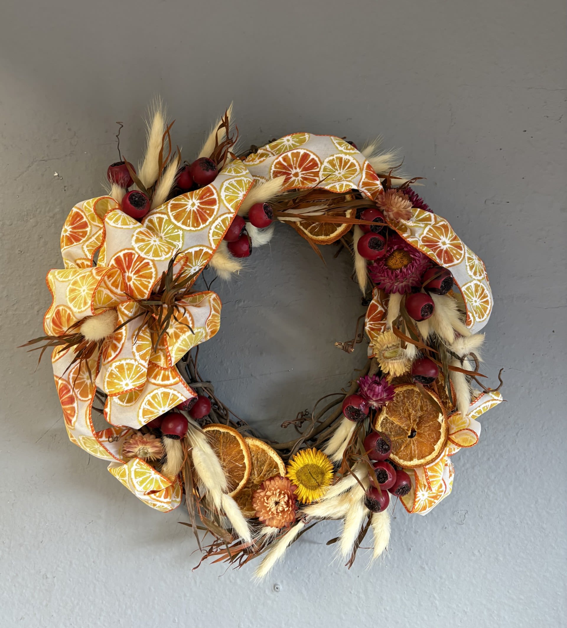 Mini Holiday Wreath (orange slices) - A fun and fesitive small wreath for the holiday season! Decorated with orange slice ribbon, silk berries and dried flowers.