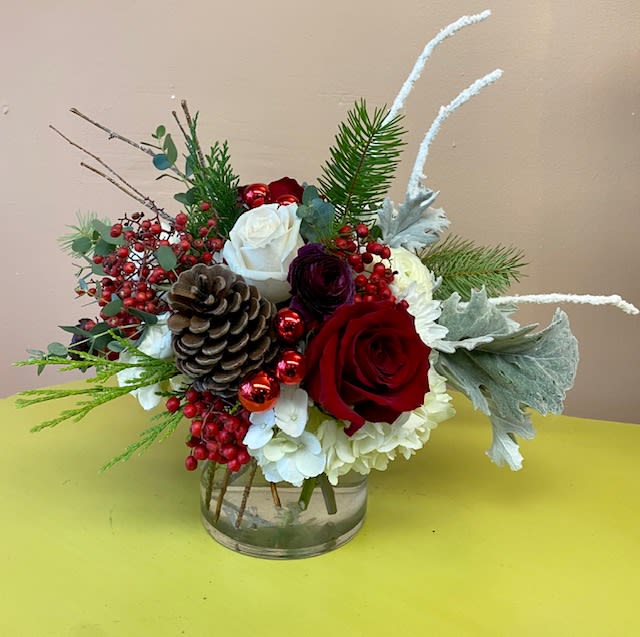 Holiday Joy - The perfect arrangement for any winter festivities. Comes in a clear 5x5 vase. 
