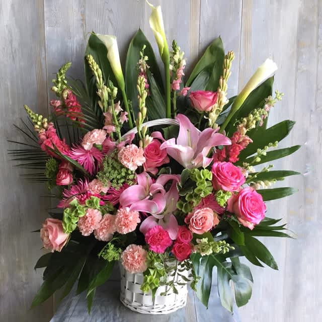 Respectful Wishes  - Sympathy Arrangement made with calla lilies, roses, carnations, bells of ireland and sand dragons. 