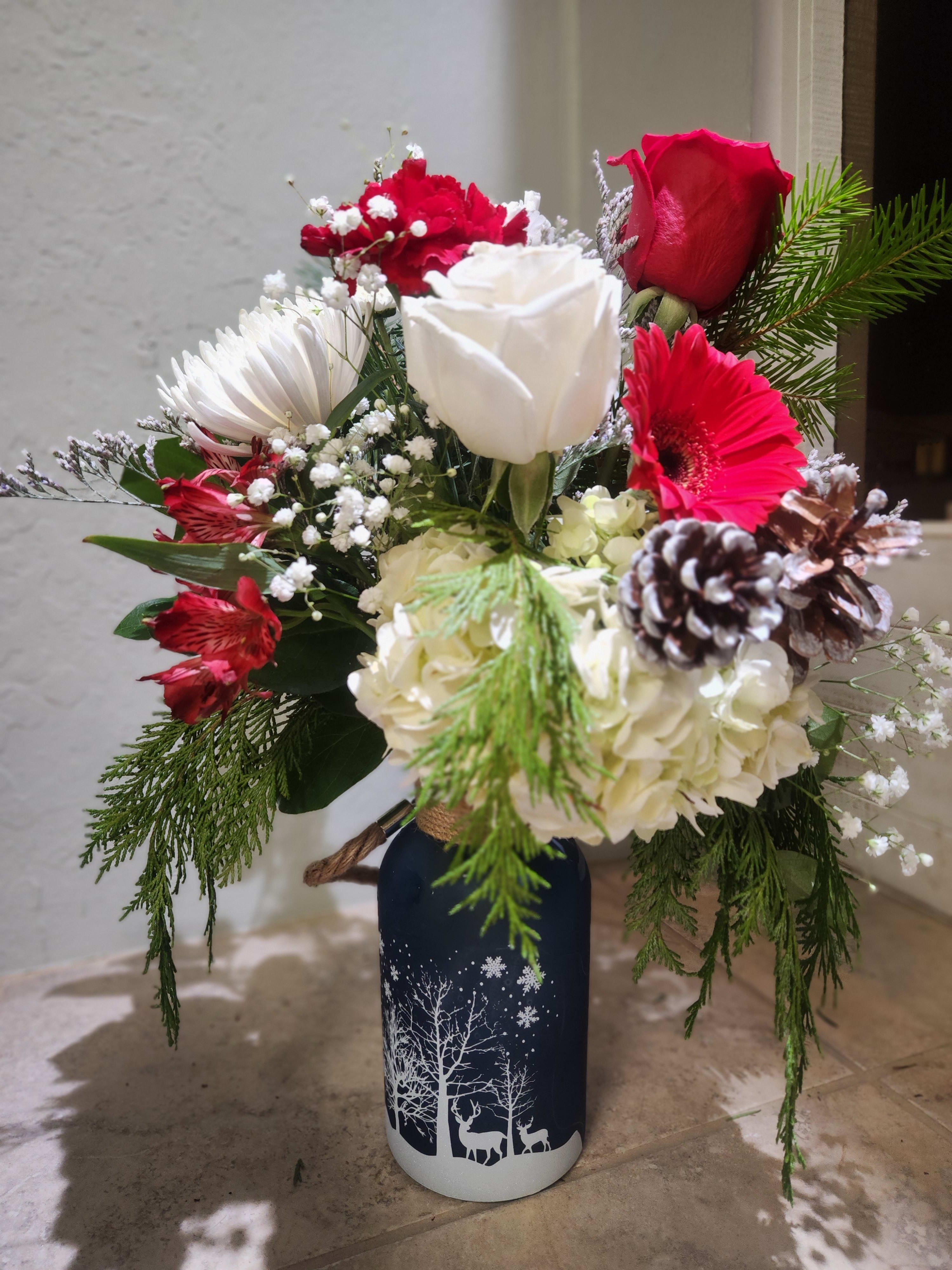 Winter collection 8&quot; glass vase   - In this style you will receive a winter collection style glass vase filled with winter evergreens Seasonal red and white blooms. 