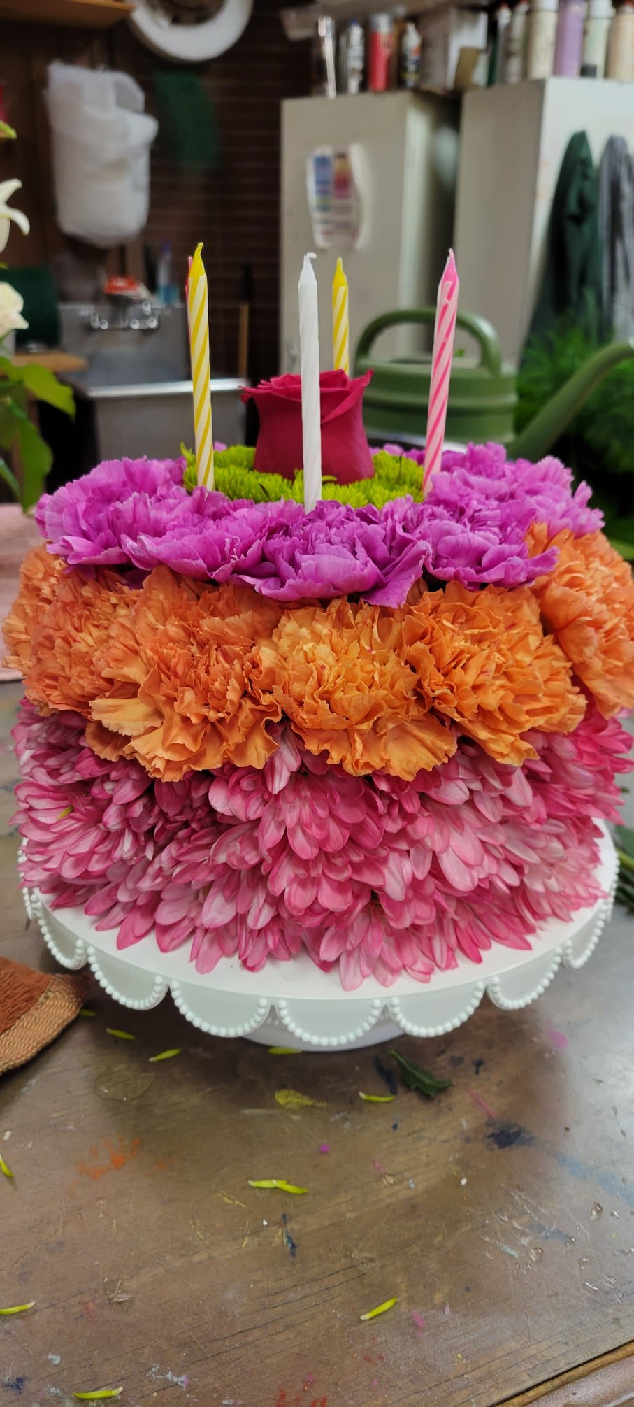 Bright Flower Birthday Cake - Fresh flower birthday cake -  this has no calories.  Made from cushion mums and carnations topped with a rose and candles added.   In bold colors and pastels - make note on the order which color