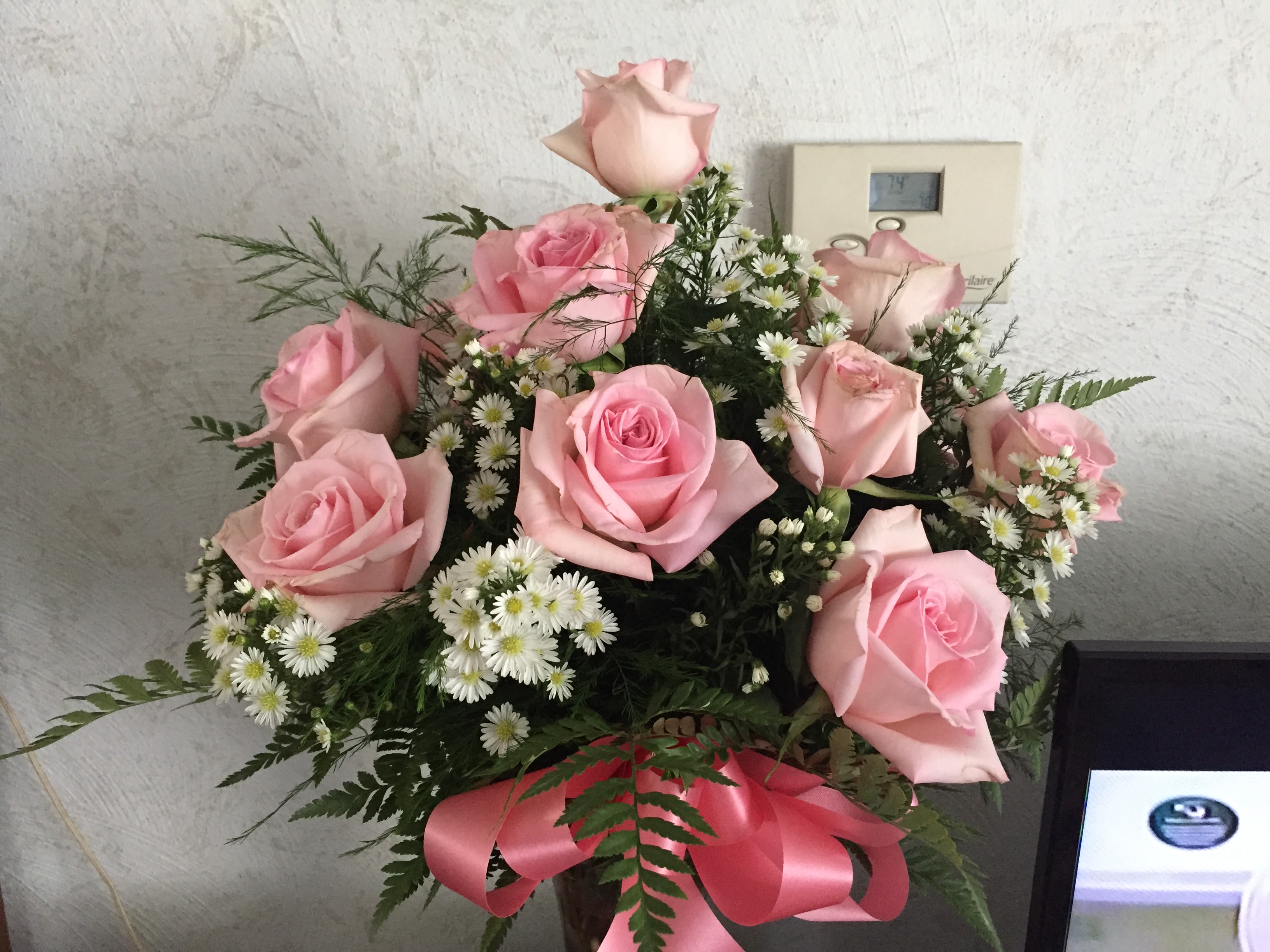 Pink Roses Vased - 12 pink roses , baby's breath or filler with greens , vase and bow  $85.00 24 pink roses,  baby's breath or filler with greens, vase and bow   $160.00 50 pink roses, baby's breath or filler with greens, vase and bow    $310.00 (color of pink may vary pending availability)