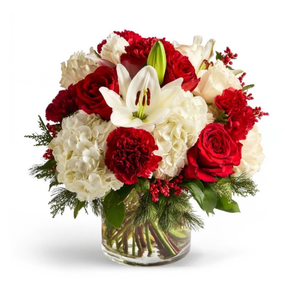 Merry &amp; Layered - PTMF-1956 - Deck the halls—and your table—with this cheerful burst of red and white. With classic roses, bold carnations, and snowy hydrangeas nestled among pine and berry sprigs, this merry mix brings luxe holiday joy to any room.
