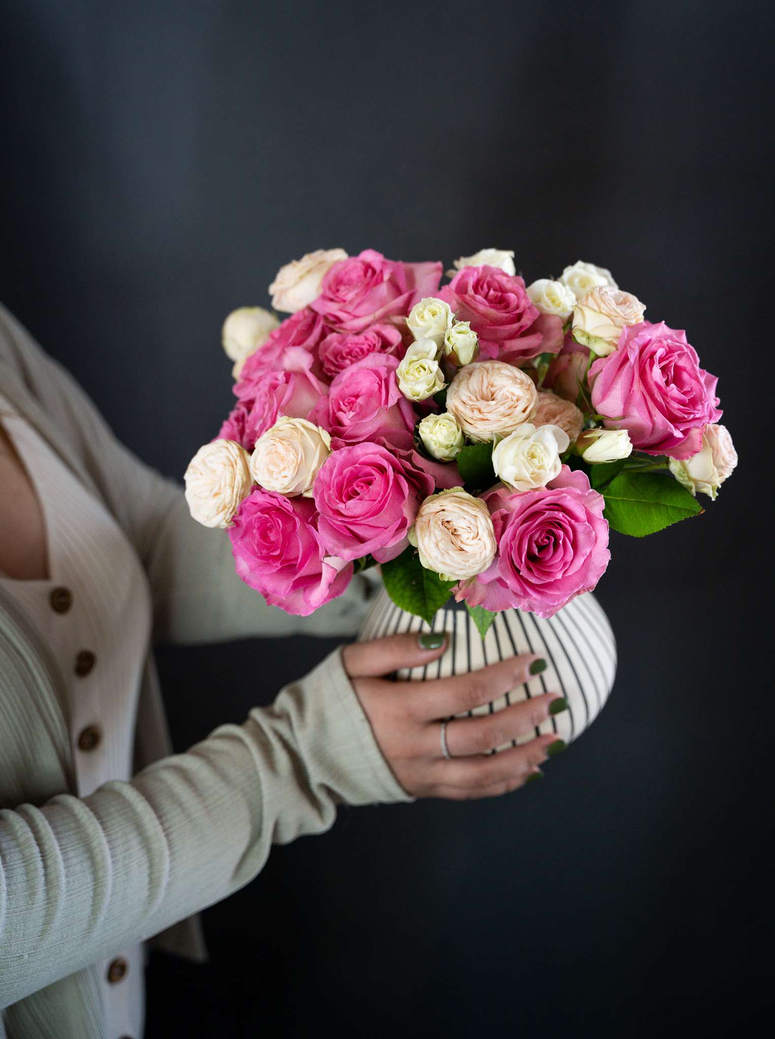 Guiliana  - Delight in the beauty of soft pink roses and garden spray roses, elegantly arranged in a stunning hand-painted striped vase. This charming arrangement is the perfect gift for someone special or a lovely addition to your home decor. Enjoy the timeless elegance and fresh beauty of this exquisite floral display. Order now for quick and reliable delivery!