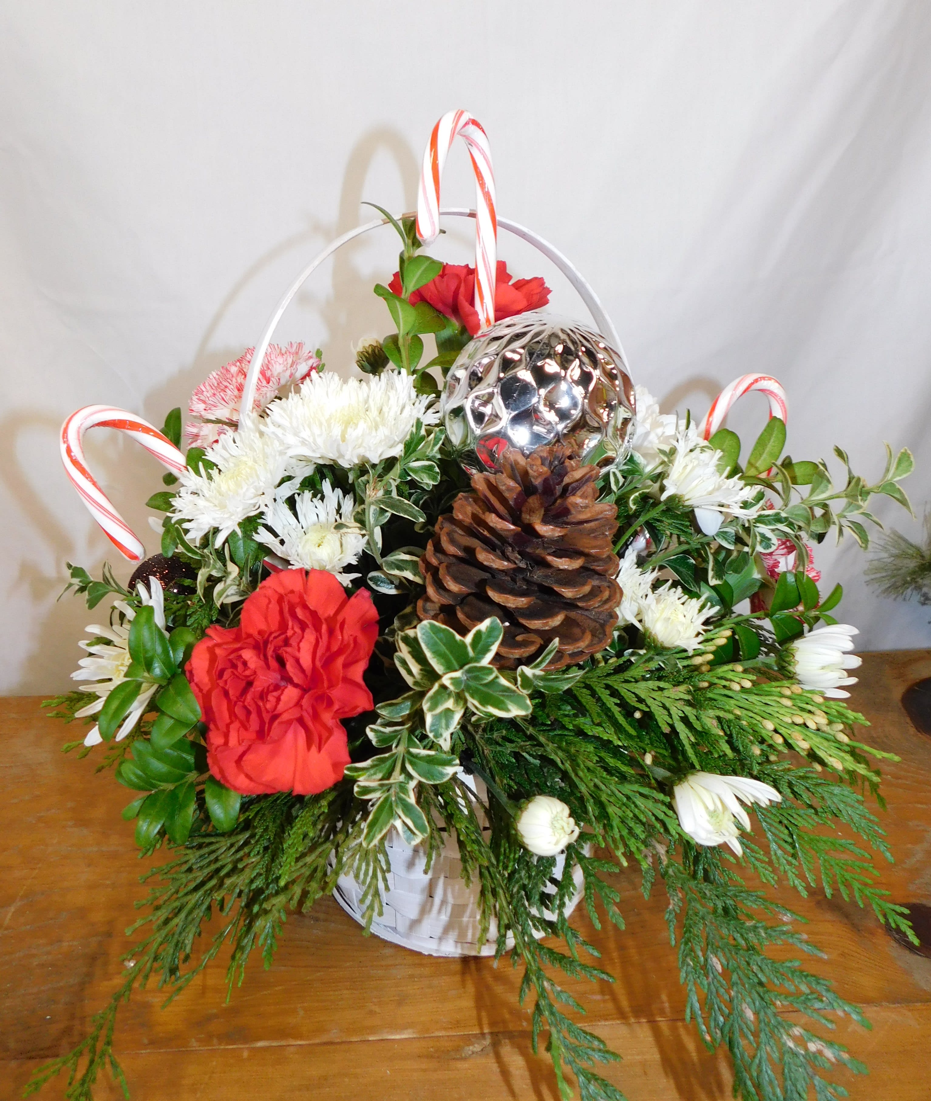 Christmas special  - Red and white flowers in a wicker basket with Christmas decoration and candy canes!   DELUXE PICTURED 