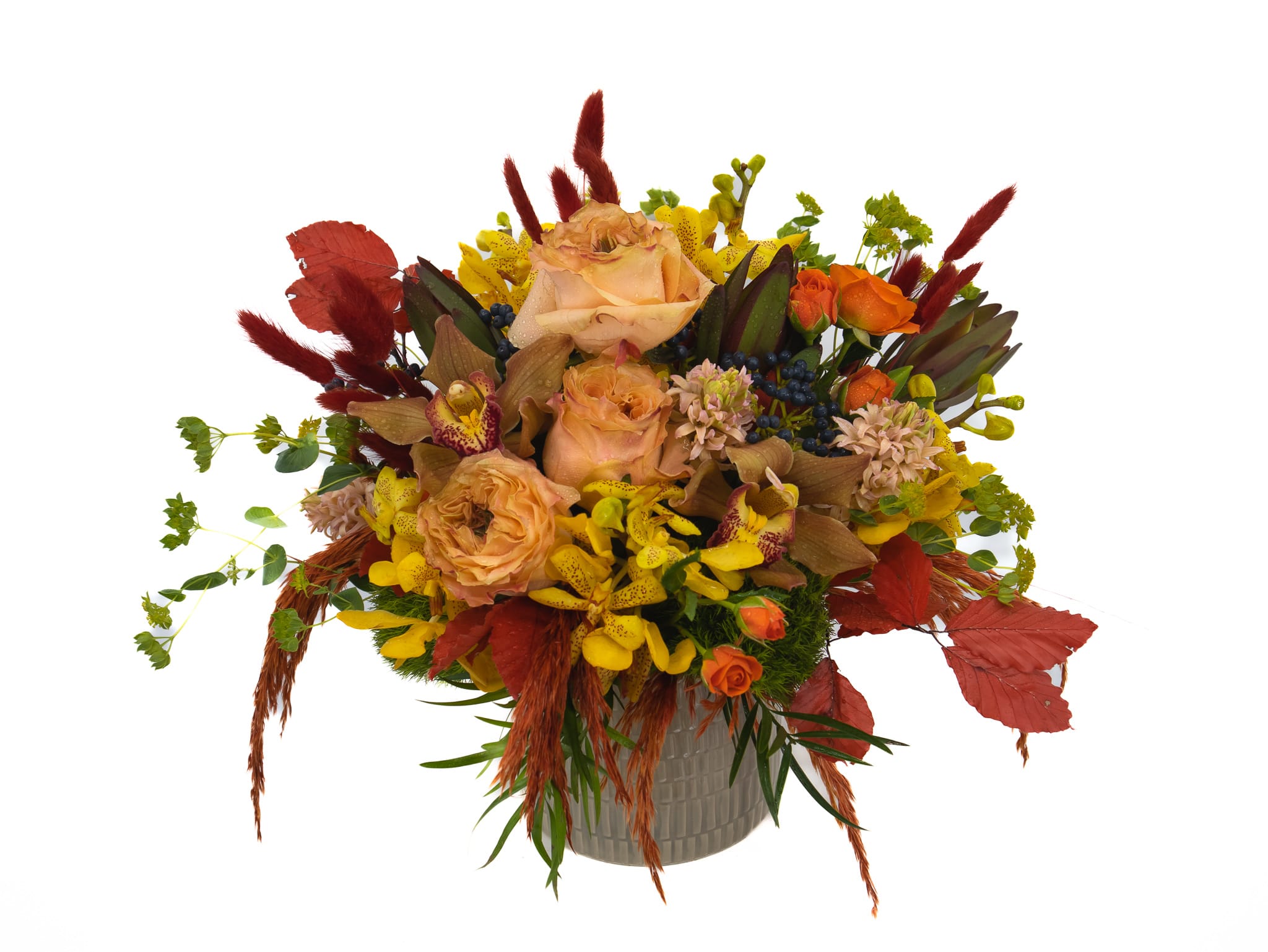 Simon - This breathtaking arrangement will magically transport anyone who views it too a gorgeous autumn landscape within seconds. Consisting of Princess crown roses, Mokara orchids, Cymbidium orchids &amp; Fall foliage mixed in. We feel this piece will check every box this Autumn.