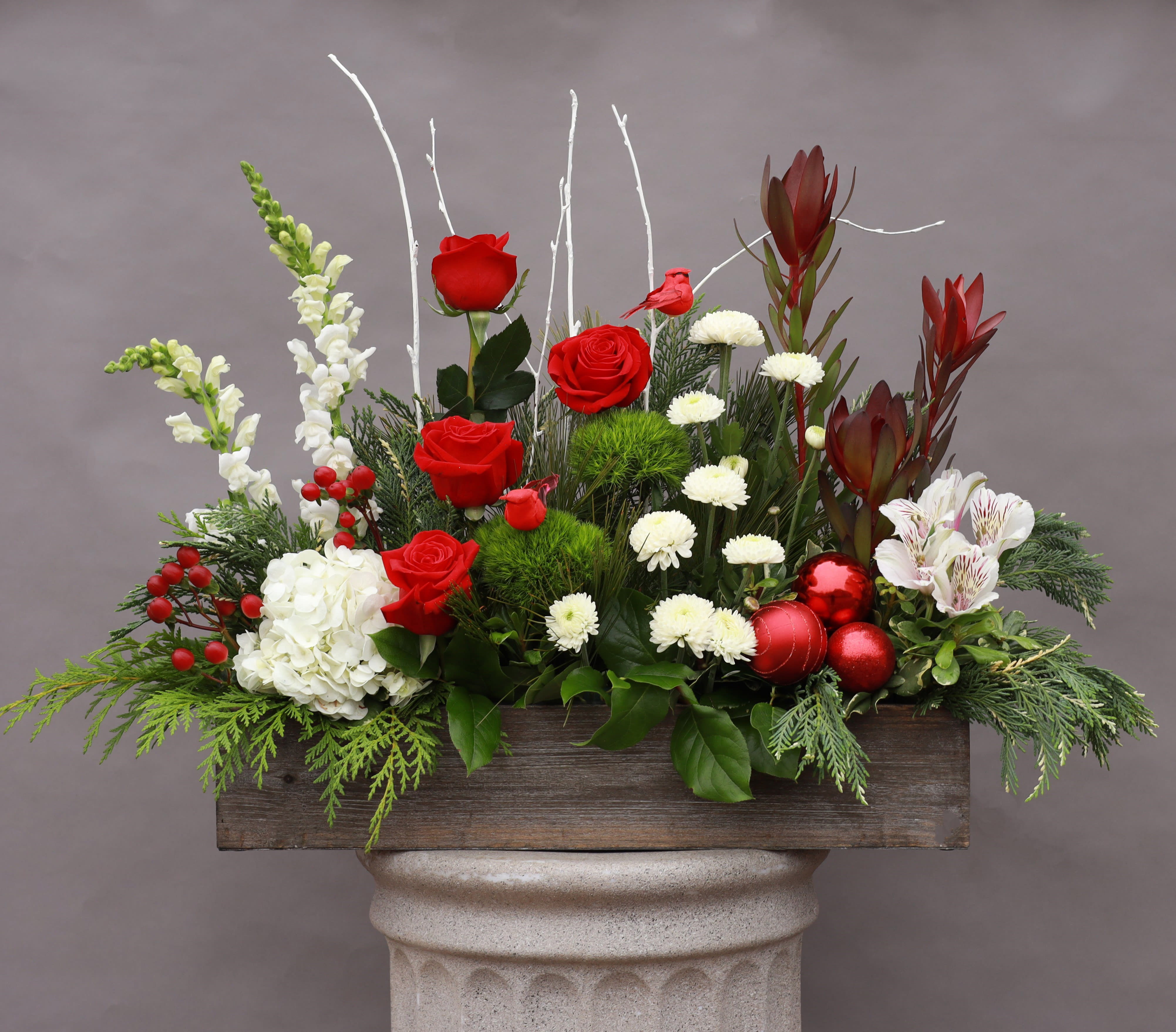 Country Christmas - A full lush arrangement with a bit of a country feel in a wood box vase.
