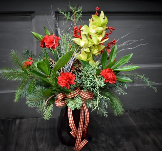 Countryside Christmas Premium - Available for Local St. Cloud, MN Delivery Only - A stroll through the countryside during Christmastime! Festive Christmas greens, carnations, orchids &amp; winterberry in a tall red rouge vase.