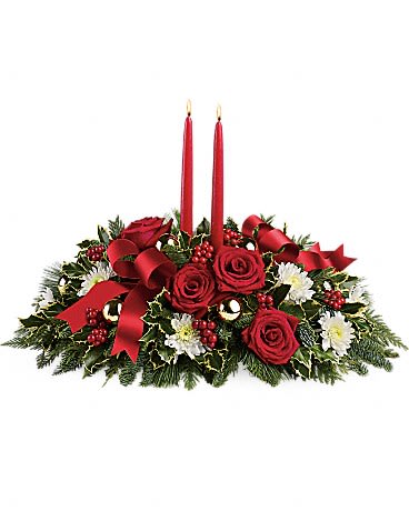 Holiday Shimmer - Make the season bright - and their table a delight - with the glowing tapers, radiant red roses and fresh Christmas greens of this stunning seasonal centerpiece.   This stunning centerpiece features red roses, white cushion spray chrysanthemums, variegated holly, noble fir, flat cedar, white pine, red berries, gold ornament balls, red ribbon, and red taper candles. •Orientation: All-Around 