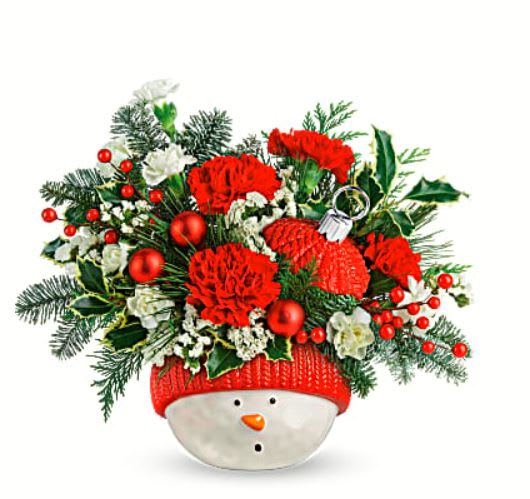 Snowman Ornament - This jolly snowman can't wait to bring his fresh, festive bouquet to your holiday celebrations! He's ready for years of Christmas fun thanks to his sturdy ceramic design and gorgeous glazed finish. Red carnations, miniature red carnations, white sinuata statice and variegated holly are accented with noble fir, flat cedar, and white pine. Delivered in Teleflora's Snowman Ornament. •Orientation: All-Around 