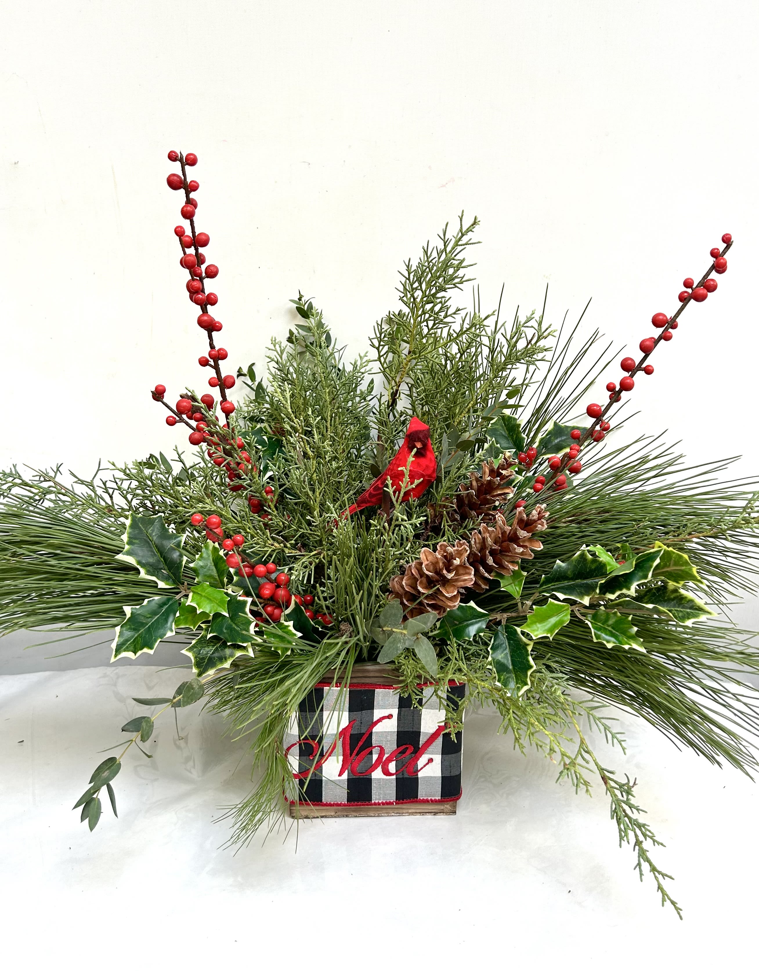 Winter Delight - Featuring seasonal favorites that will dress your table for the entire holiday season, &quot;Winter Delight&quot; is created with seasonal greens and finished with the Noel ribbon!