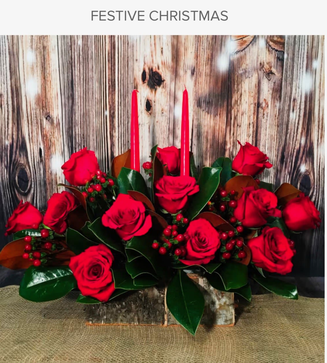 All Red Holiday Centerpiece - Set the holiday table with a traditional favorite! Fresh and fragrant Christmas greens create a fragrant base for the rich red roses and carnations in our merry red centerpiece. Accented with berries, red ornaments and ribbon, this classic arrangement comes with a hurricane vase and pillar candle to create a warm and cozy atmosphere for your Christmas celebration.