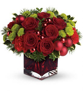 Teleflora's Merry &amp; Bright - Gorgeous red roses and carnations along with brilliant green button chrysanthemums, shiny red ornament balls and winter greens are perfectly arranged in this very merry Christmas cube. Approximately 13" W x 11 1/2" H. T125-1A