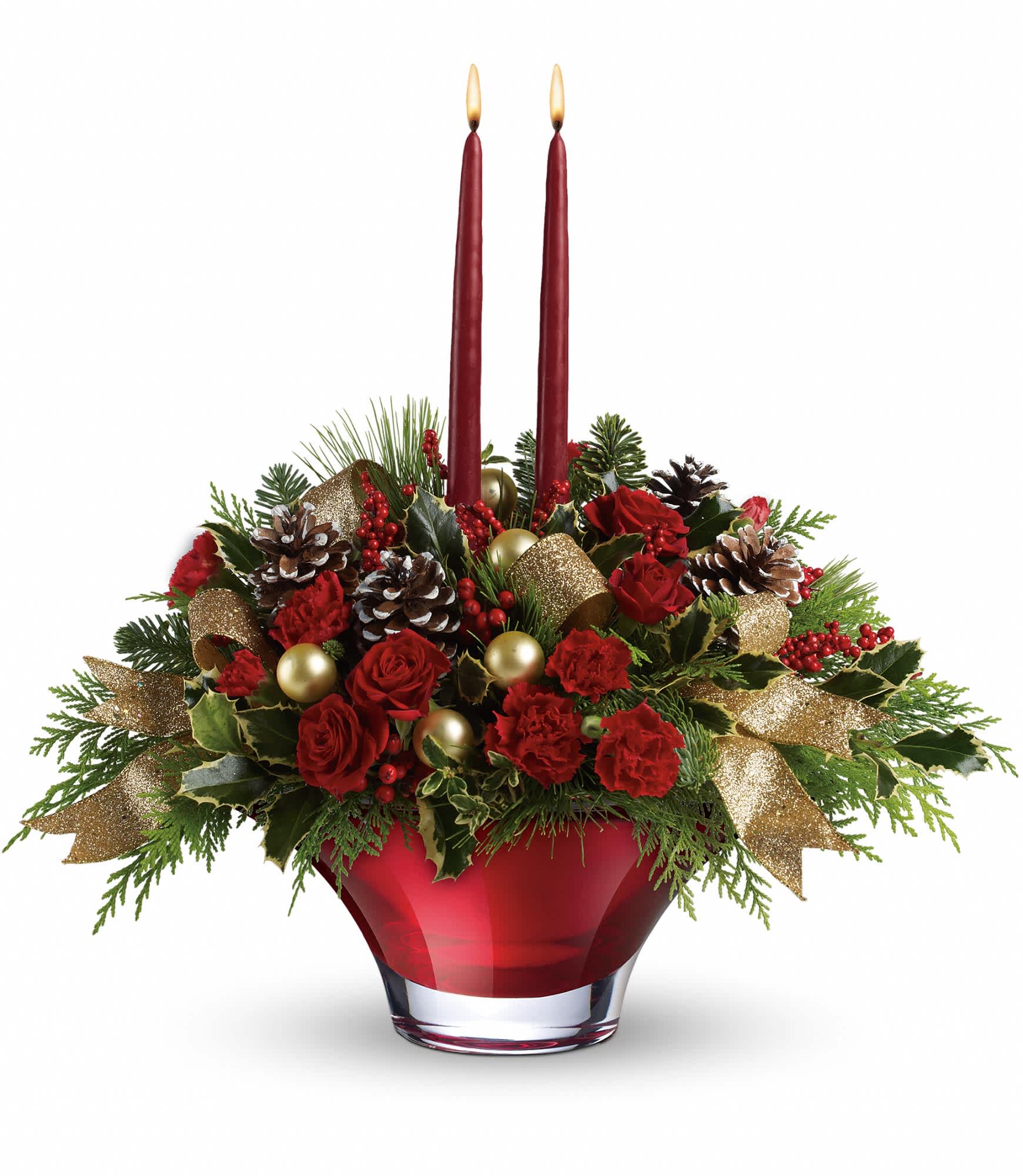Teleflora's Holiday Flair Centerpiece - This centerpiece features red spray roses, miniature red carnations, flat cedar, variegated holly, noble fir, oregonia, white pine, red berries, frosted pinecones, gold ornament balls and beautiful golden ribbon beneath two red taper candles. Delivered in an exclusive Holiday Flair bowl. Approximately 18 1/2" W x 17" H.  T13X200A