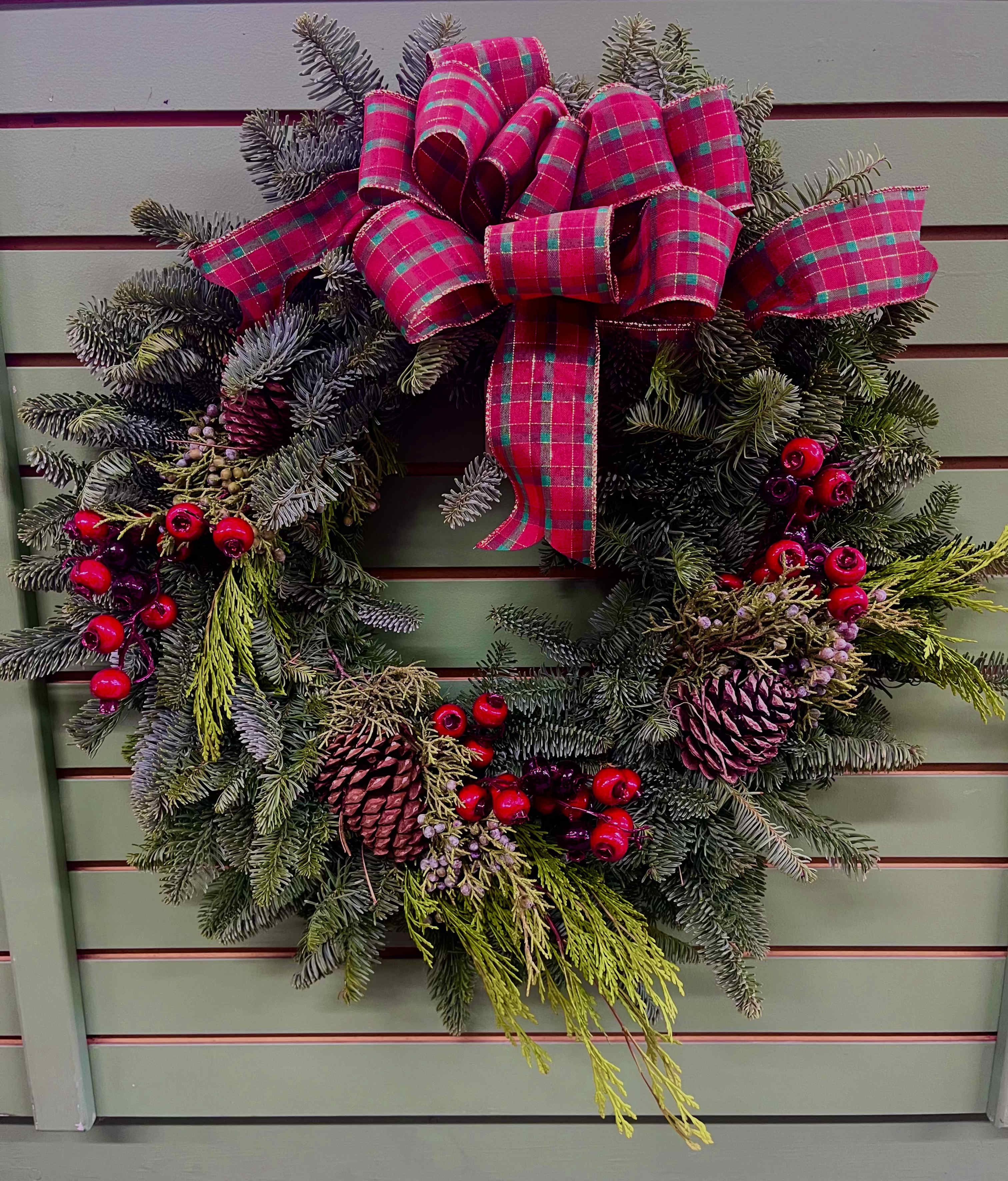 Holiday Wreath - It's that time of the year where we decorate our homes with Christmas cheer! Add a classy and classic holiday wreath to your front door or send one to a friend or loved one.  Everyone is sure to love this fragrant wreath that has berries, pinecones, and a beautiful bow!