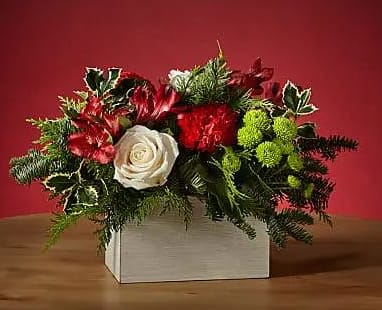 Snow Ball Bouquet (BB) - Dress the tablescape in winter wanderlust with our Snow Ball Bouquet and add an air of sophistication with the elegance of white roses. The holly lays over a white wooden box, perfect for a tasteful holiday gathering. Available for same day delivery throughout Boca Raton and the surrounding areas. 