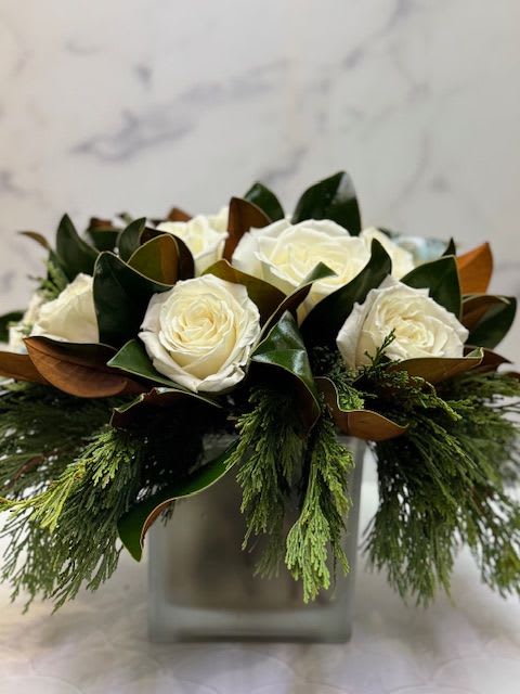 Classic Winter  - Arrangement filled with winter greens, magnolia, and white roses
