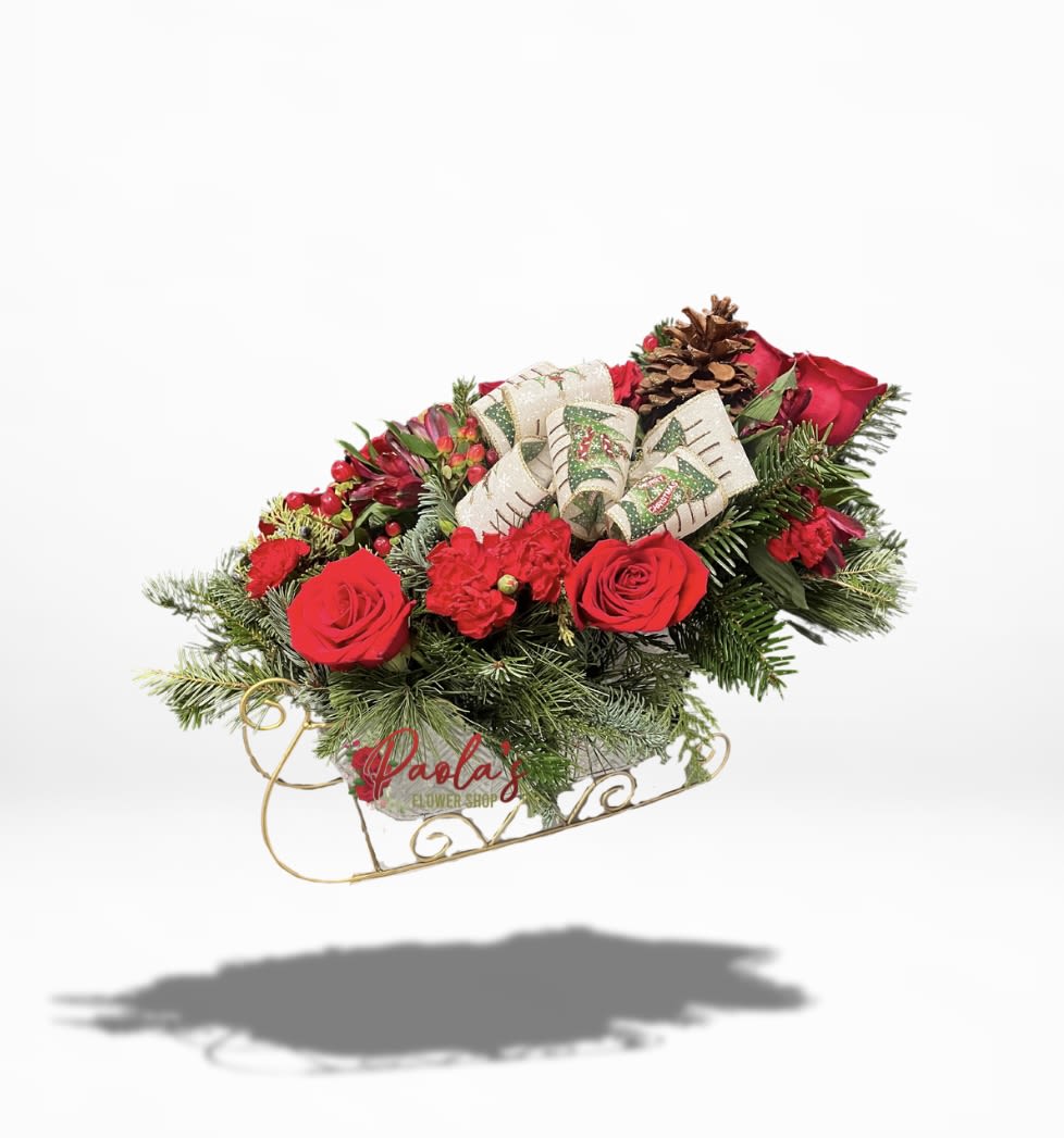 Gleaming Silver Christmas Sleigh - Get ready to be dazzled this Christmas Day! This festive delight features a charming mix of pine cones, roses, vibrant red berries, cheerful carnations, elegant alstroemeria, and, of course, a fabulous Christmas bow!