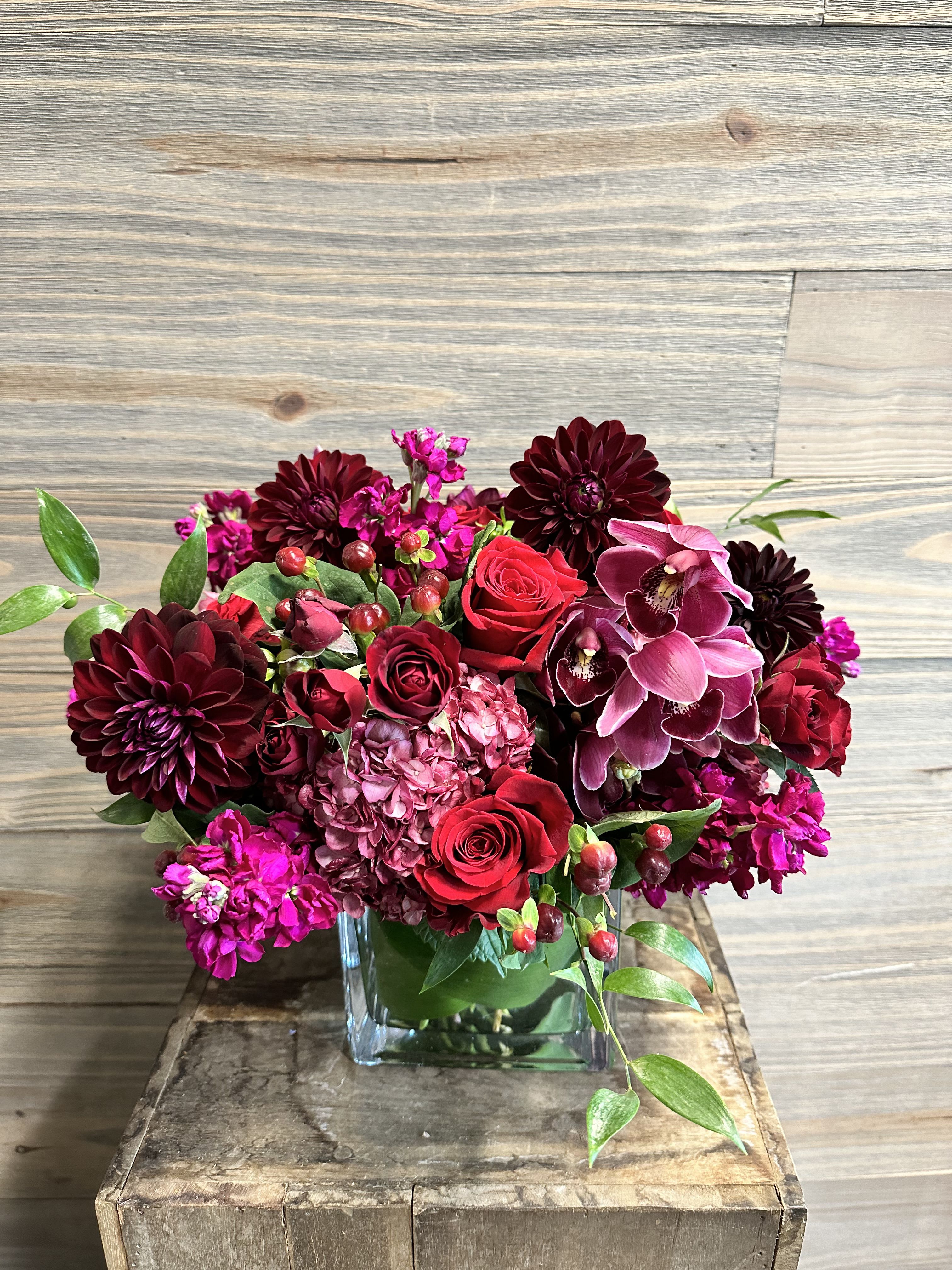 Red Velvet - A fuller fall bouquet of romantic premium blooms in shades of red, burgundy, plum and fuchsia. 