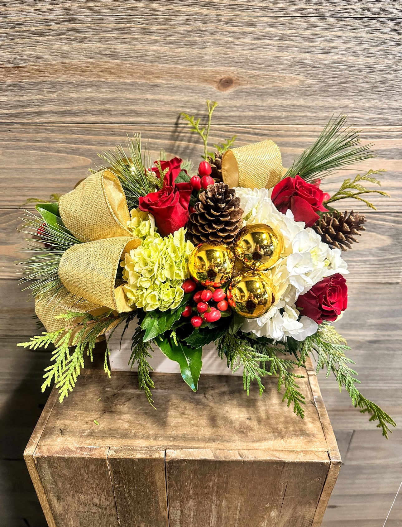 Eve - A beautiful centerpiece perfect for the holiday table- with a combination of red, white, gold and green flowers and accessories in a specialty holiday box!