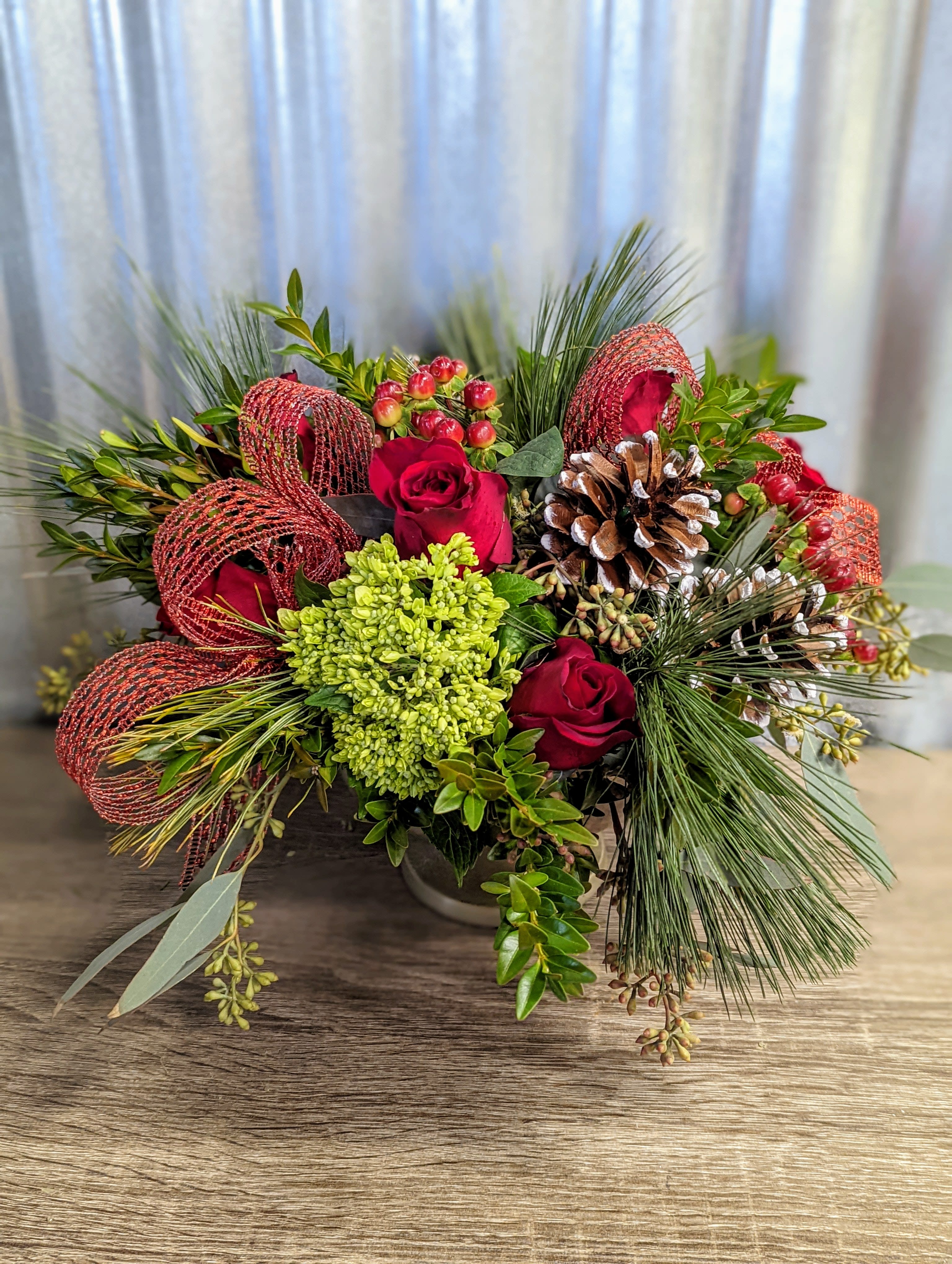 Skadi - Beautiful reds, pinecones, holiday greenery and hydrangeas in a pedestal gold bowl.  