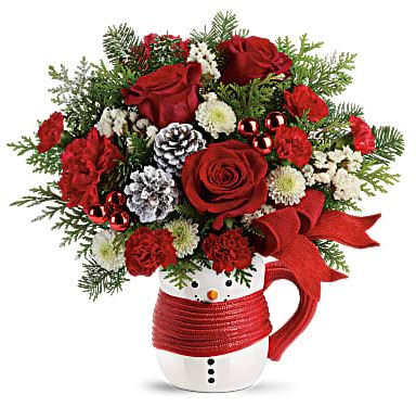 Christmas Mug Bouquet - This sweet mug bouquet features red carnations, red miniature carnations, white button spray chrysanthemums and a variety of winter greens. Orientation: One-Sided. The mug will vary depending on availability.