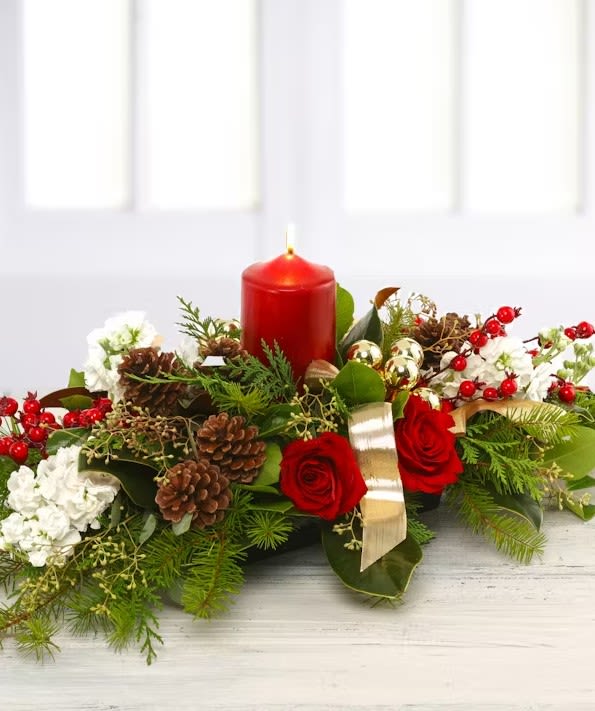 Thankful Christmas Centerpiece - A timeless classic Christmas centerpiece featuring a holiday pillar candle, scented woodland firs and pine, fragrant garden stock, roses, holiday berries, silver eucalyptus and gold ribbons. Approx 11&quot;x18&quot;