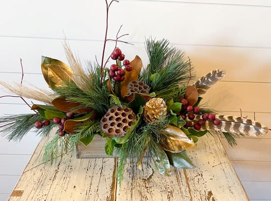 Wonderland Bouquet - This beautiful, long arrangement is nature inspired with fresh Christmas greenery, lotus pods, berries, magnolia, dog wood and feathers!   No fresh blooms, only fresh greenery. This arrangement is sure to last a LONG time!