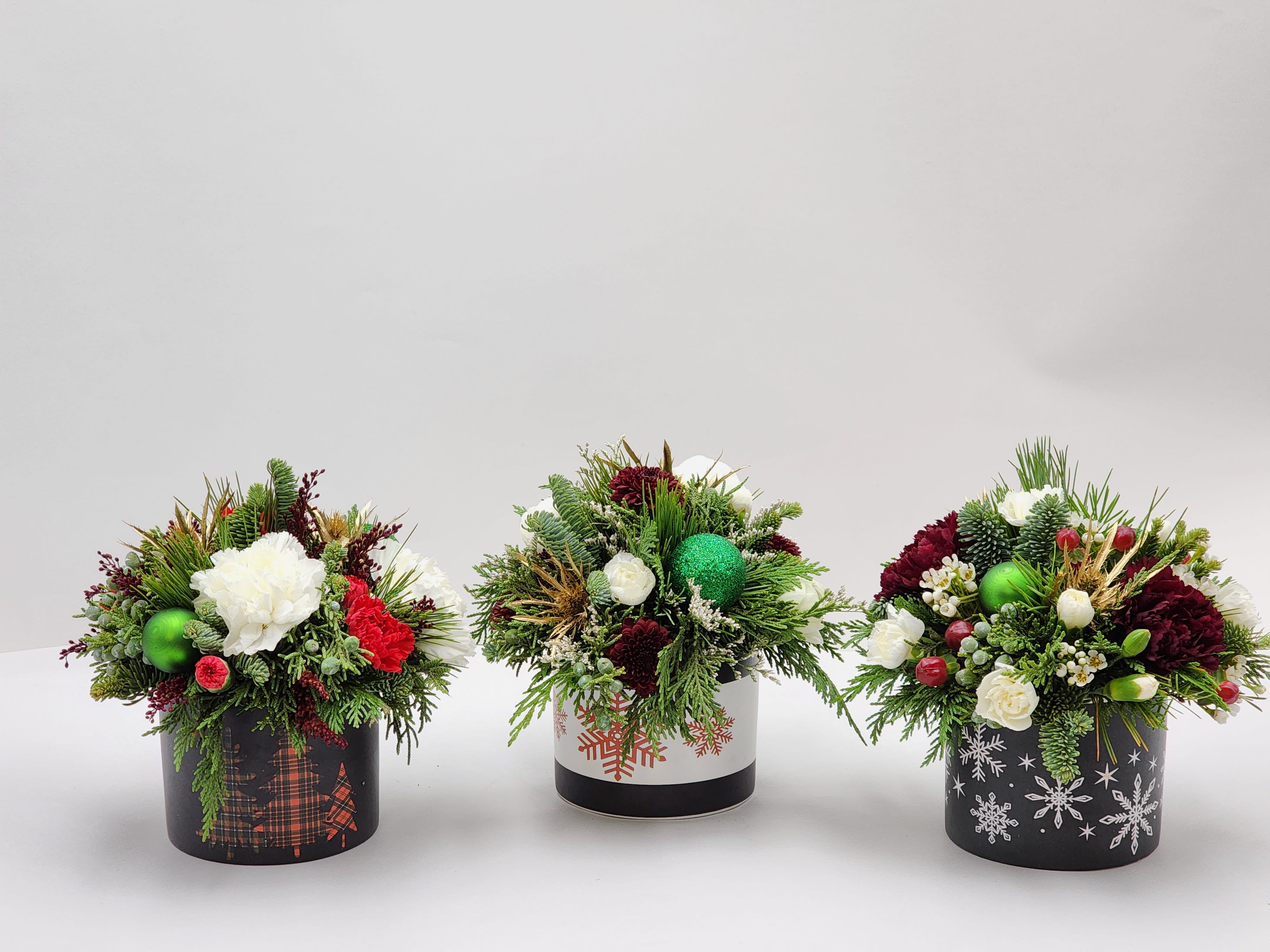 Home Sweet Holidays Set of 3 - Select this unique set of 3 Christmas themed arrangements perfect to spread along a table as a centerpiece or around the house. Each arrangement is approx. 7.5&quot;W x 7&quot;H