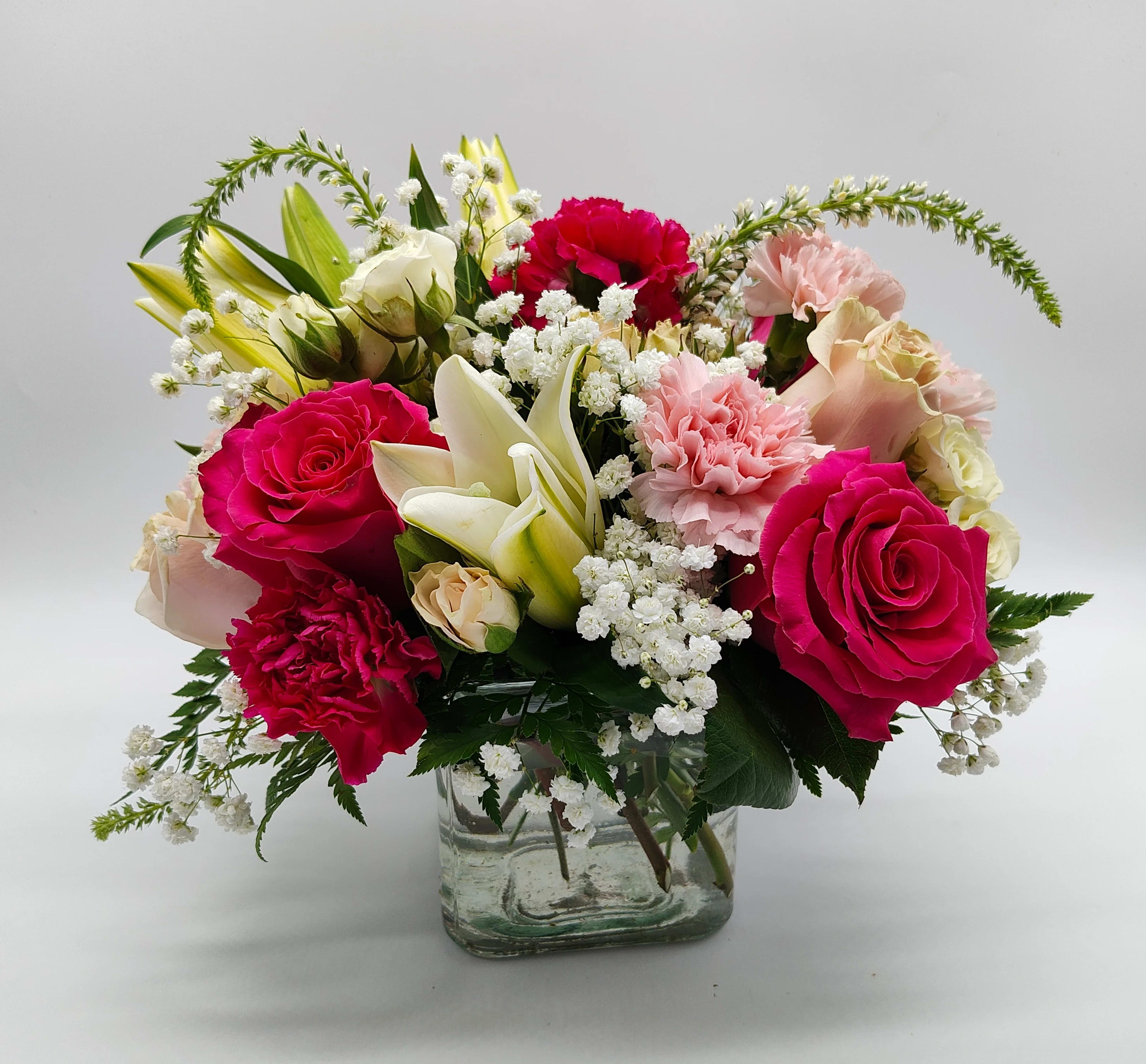 Delightfully Pink  - Shades of pink flowers and touch of purple and designed in a pretty cube. Delightfully Pink. Approximately 10 in. by 10 in.