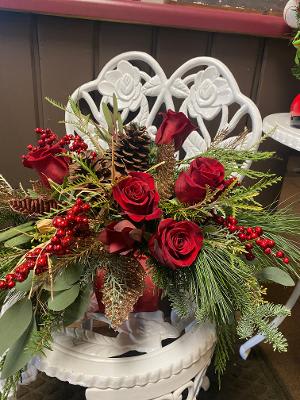 Home for the Holiday  - This beautiful arrangement is filled with elegant red flowers, berries, and lush holiday greens. 