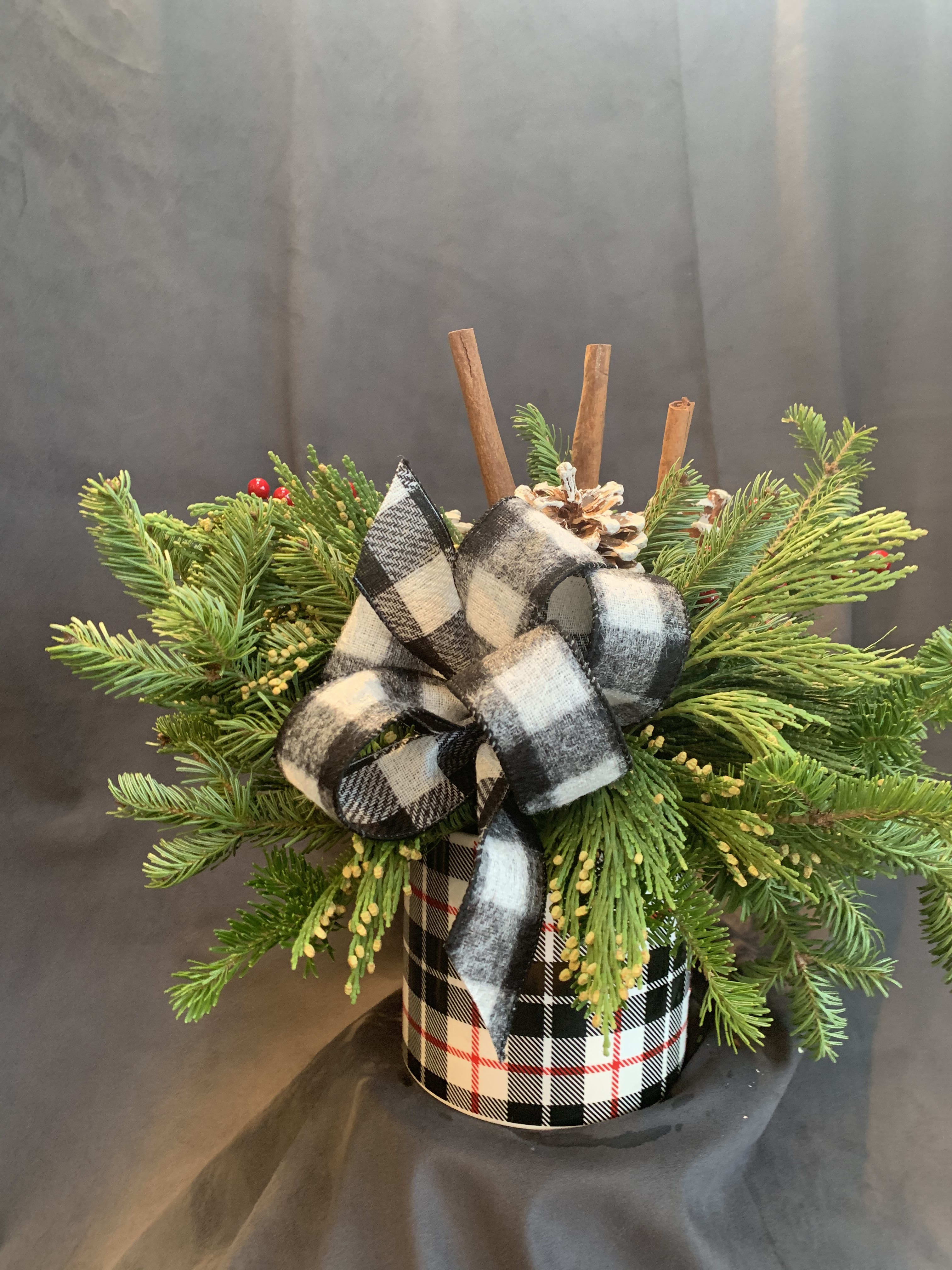 Buffalo check Christmas - Buffalo check vase filled with mixed ever greens, pine cones, berries and plaid ribbon.