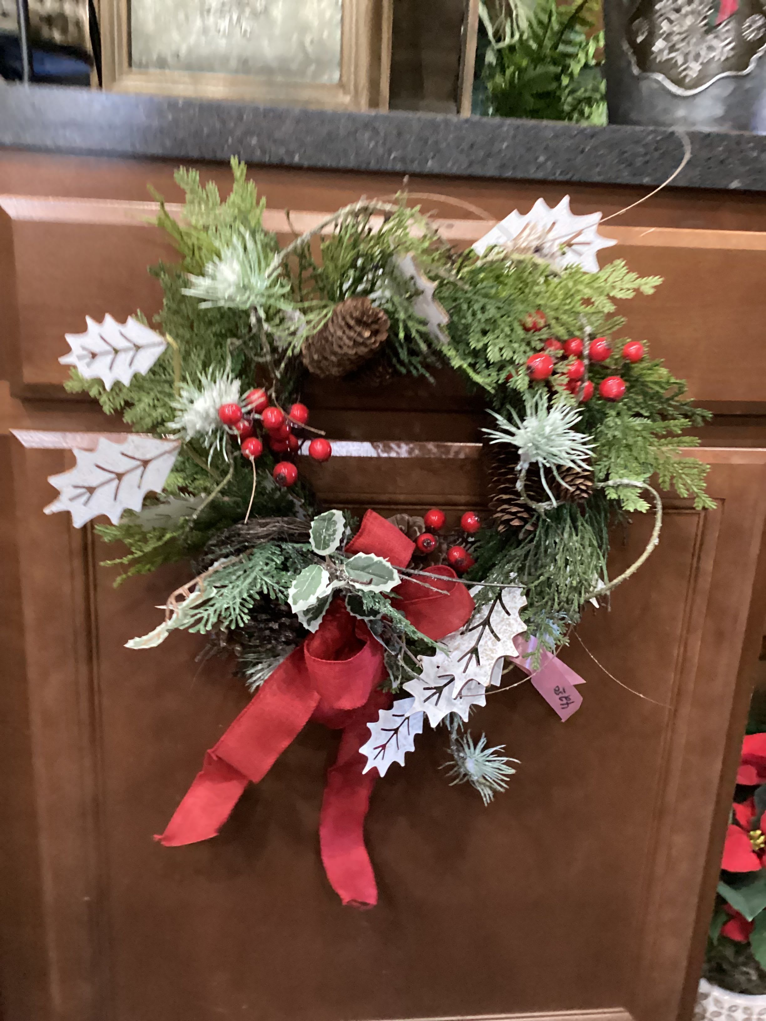 Small Permanent Red and White Wreath - A small holiday wreath decorated with white leaves and red holly berries 