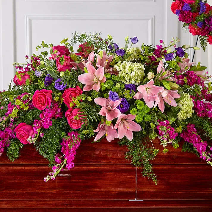 Radiant Tribute Casket Spray - Our Radiant Tribute Casket Spray adds a brilliant spectrum of pinks, greens and purples to every celebration of life. With a collection of stock, hydrangea, lisianthus and roses, our talented designers craft this grand gesture to capture beauty and brightness in every expression of sympathy.  Details The Standard Spray is approximately 11"H x 47"W. Designed by florists, ready to display. Pet Safety Precautions: This bouquet or plant may include flowers and foliage that are known to be toxic to pets. To keep them safe, be sure to keep this arrangement out of your pet's reach.