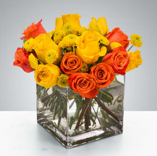 Cheer Up Buttercup by BloomNation™ - Yellow and orange roses come together for a fun and fresh arrangement. A great arrangement to send to both men and women as a gift, these flowers light up any room. Send this for admin professionals week, Cinco De Mayo, or a birthday.  Approximate Dimensions: 10"D x 10"H