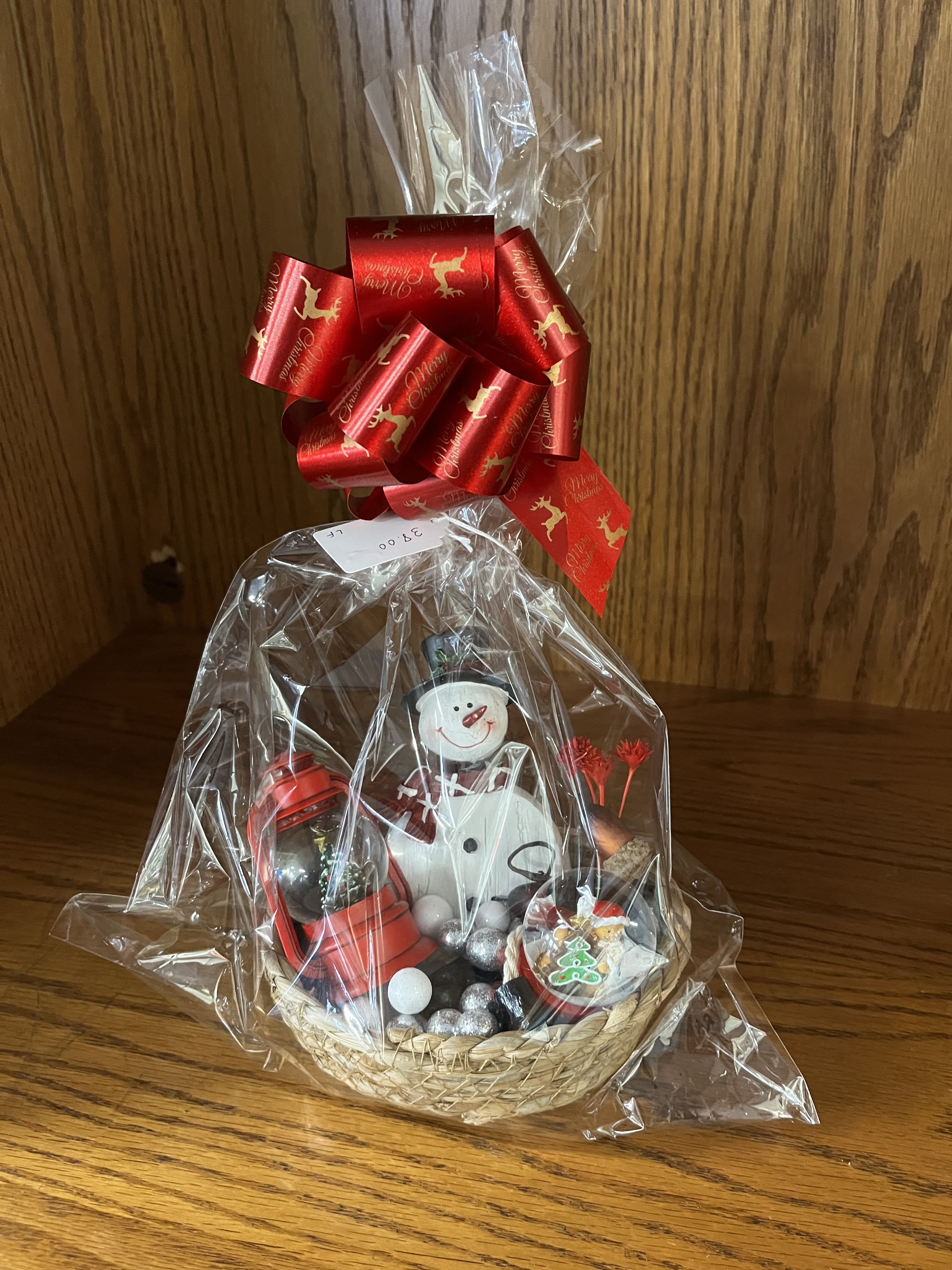 Christmas Basket - Includes: Lantern Snow Globe with a tree, Snow Globe with a gingerbread man, and a Snowman figure.