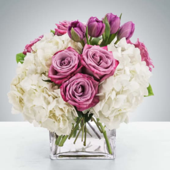 Here for You by BloomNation™ - Express your condolences after the loss of a loved one with flowers. Sending this clean purple and white arrangement featuring lavender roses and white hydrangea is a way to show you care and are thinking of them.  Approximate Dimensions: 11"D x 11"H