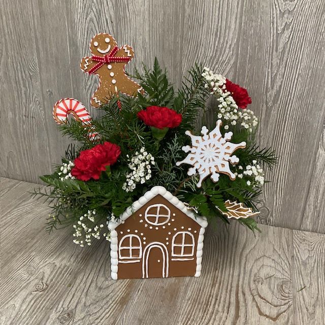 Genger's Bread House - Ceramic keepsake Gingerbread house filled with long lasting Christmas greenery and festive red and white flowers.   