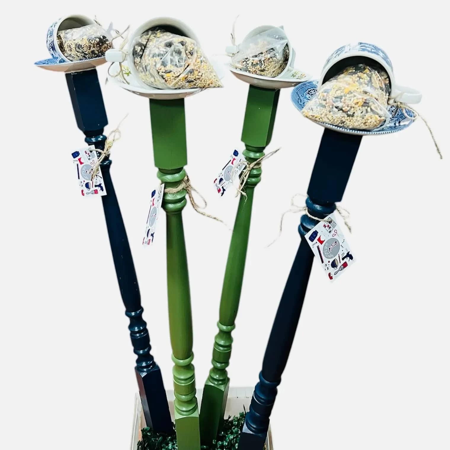 Tea Cup and Saucer Bird Feeder - Send this unique gift today! A spindle fitted with a stake, topped with a charming teacup and saucer, filled with a bag of birdseed. Add some charm and nature to a loved one's day!