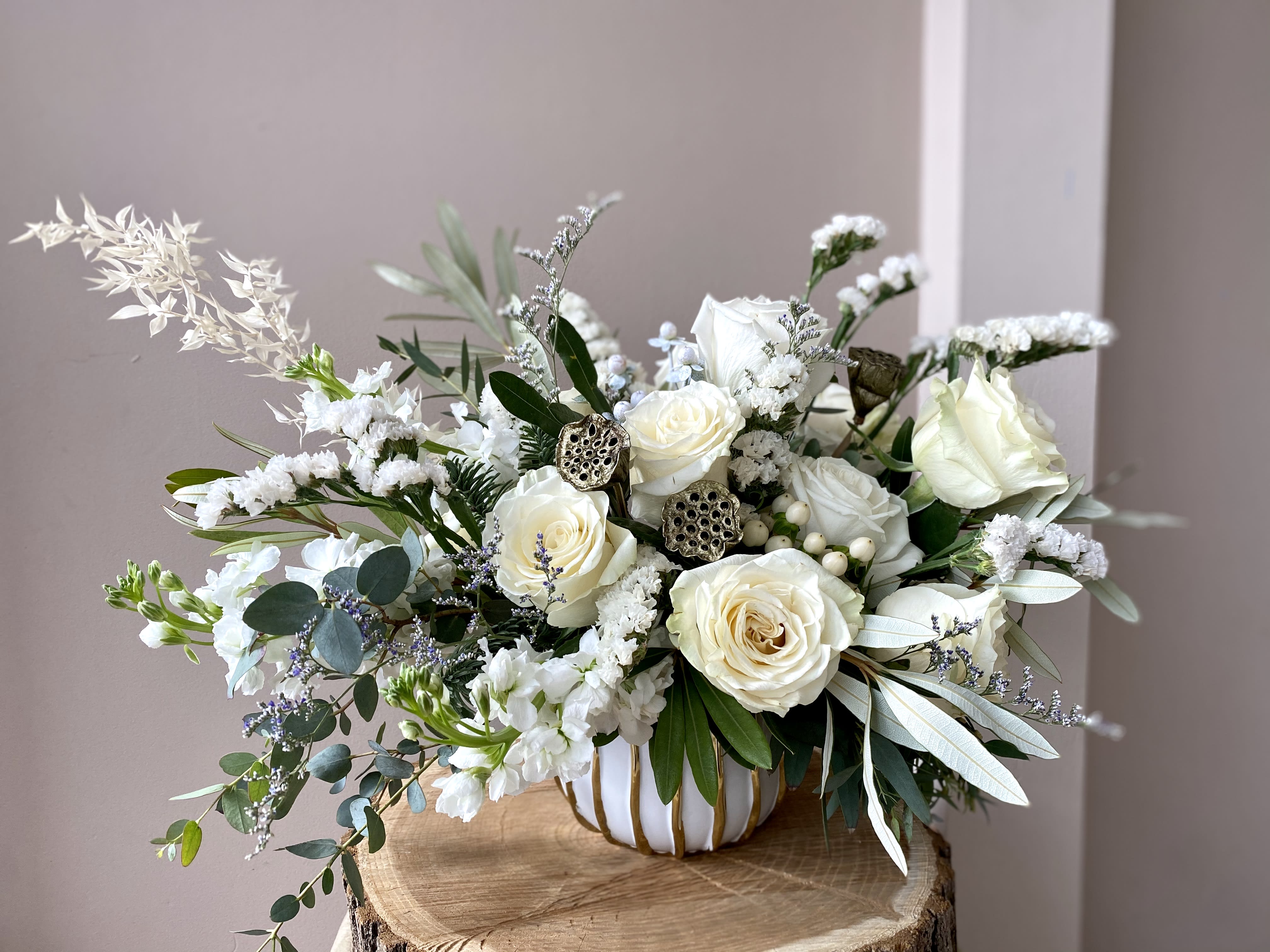 The Snow Queen is here! - "The Snow Queen danced, as snowflakes fluttered down, Piled in the forests, Piled in the town." -  Send your loved ones the blooming white Holiday wishes! Fragrant white roses, stock and seasonal greenery will make their hearts smile and their Souls dance! A perfect blooming centerpiece to welcome magical season in! 