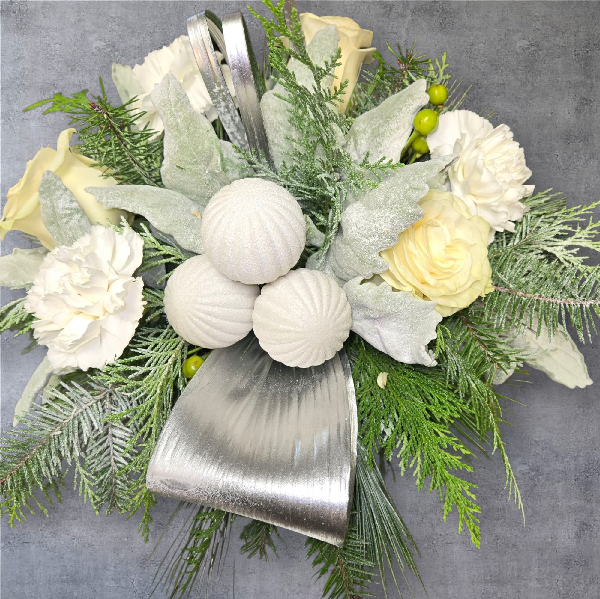 Winter - White Roses,carnations, Christmas greenery, aspedistria, Lilly grass,dusty Miller.