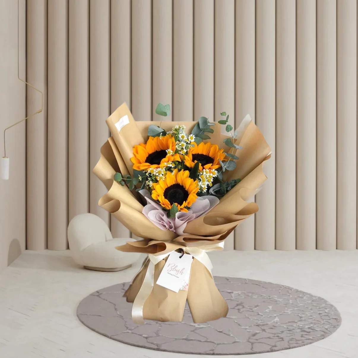 Sunshine Bouquet - Brighten someone's day with this cheerful and vibrant bouquet featuring radiant sunflowers, delicate white blooms, and lush greenery. Wrapped in rustic kraft paper with soft pastel accents, this arrangement captures the warmth of sunshine and the beauty of simplicity — a perfect gift to express joy, positivity, and heartfelt wishes.